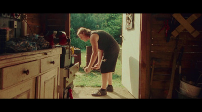 a woman standing in a doorway of a kitchen