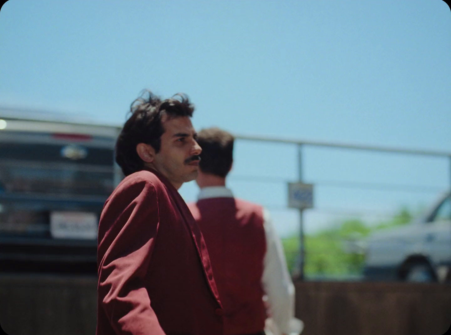 a man standing next to another man on a street