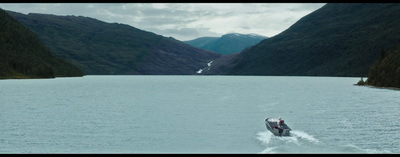 a small boat traveling through a large body of water