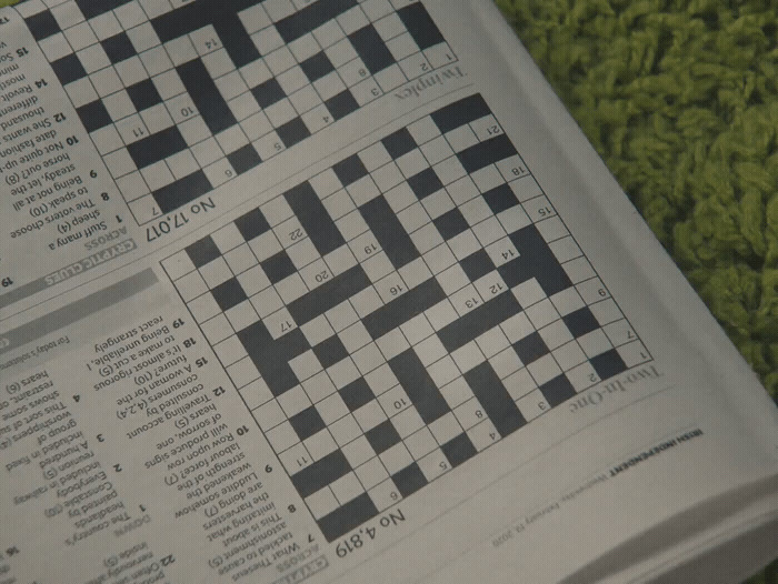 a close up of a crossword puzzle book