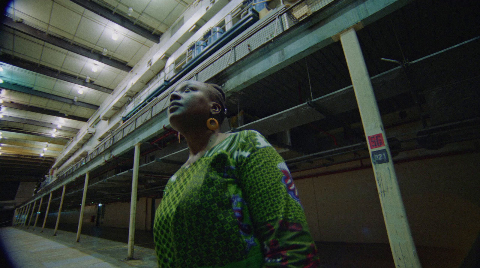 a woman is standing in a parking garage