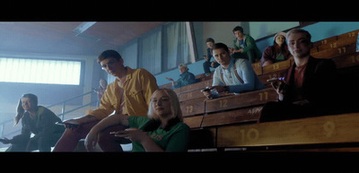 a group of people sitting in bleachers watching something