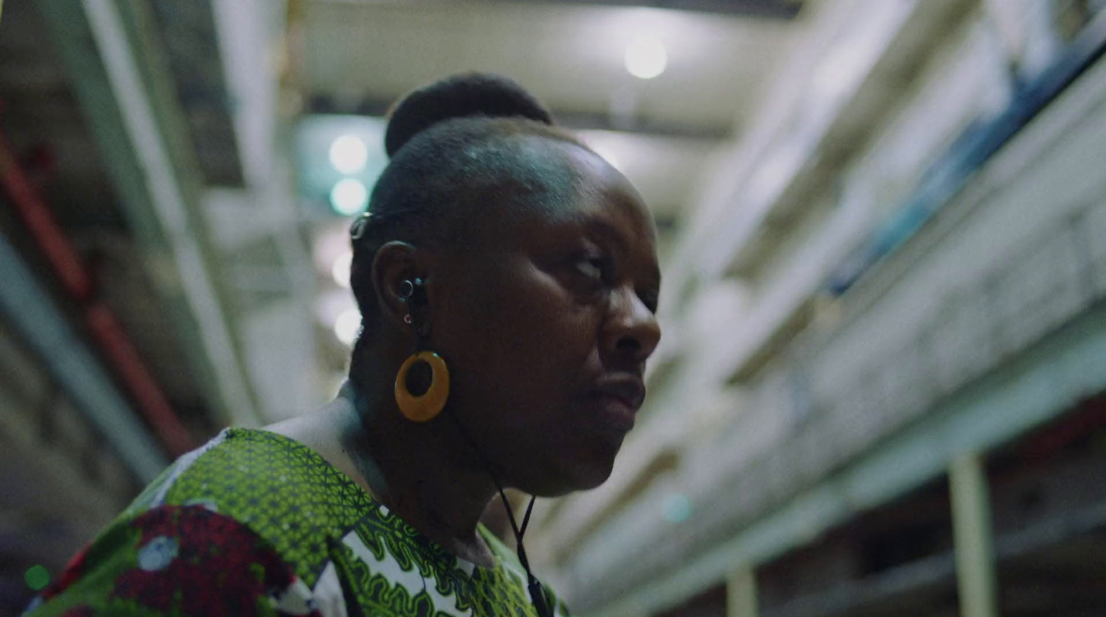 a woman in a green dress with ear rings