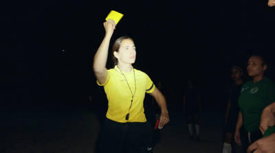 a man in a yellow shirt holding a yellow frisbee