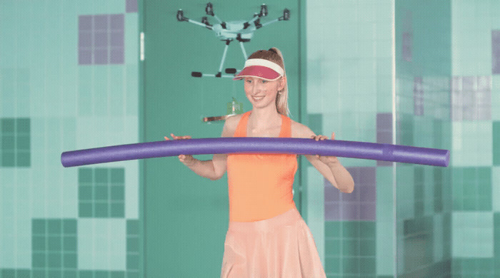 a woman in a pink dress holding a purple object