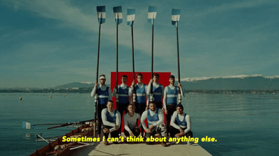 a group of people standing on top of a boat