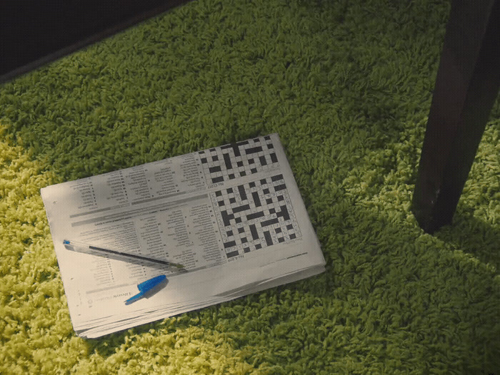 a newspaper laying on top of a green rug