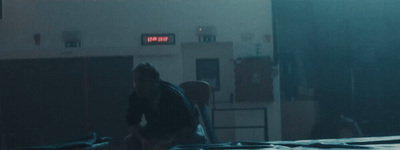 a man standing in a room with a clock on the wall