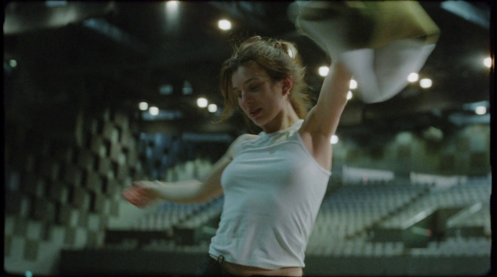 a woman holding a tennis racquet on top of a tennis court