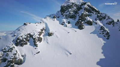 a mountain covered in snow with a sky background