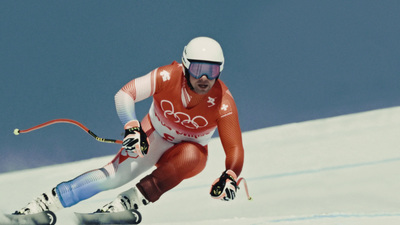 a man riding skis down a snow covered slope