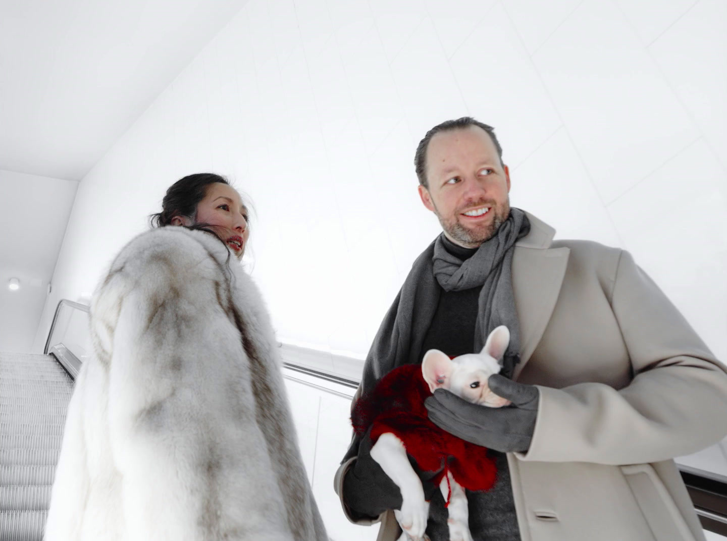 a man and a woman walking down an escalator