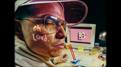 a man wearing glasses and a hat with writing on his face