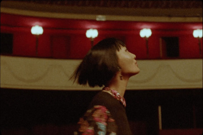 a woman standing in front of a red stage