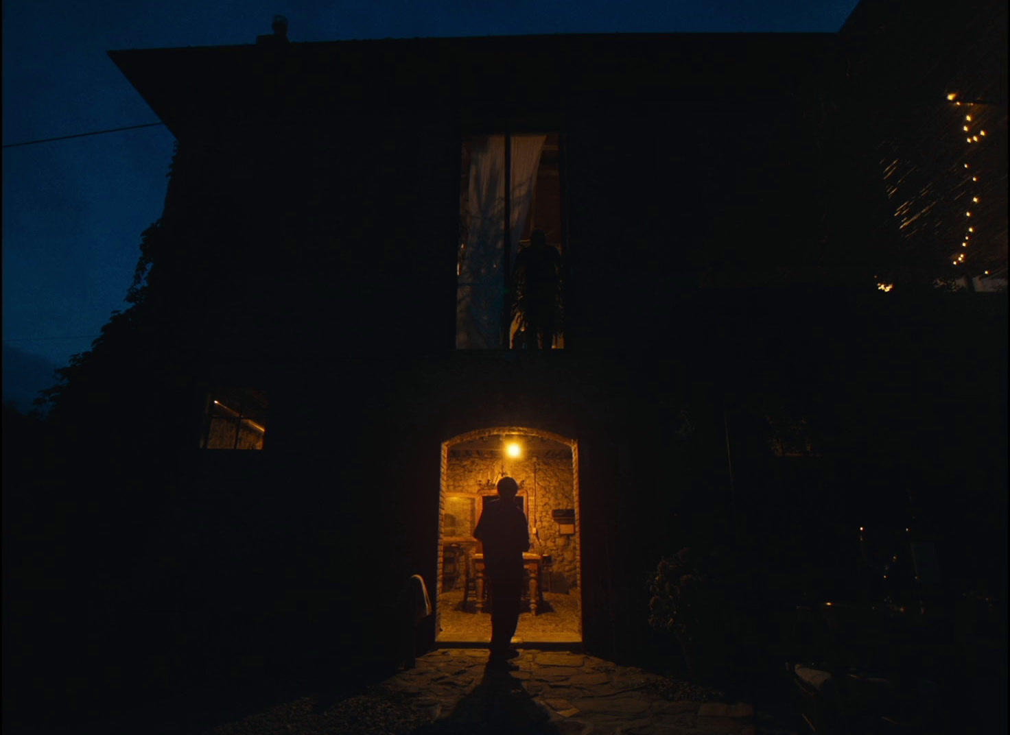 a person standing in a doorway at night