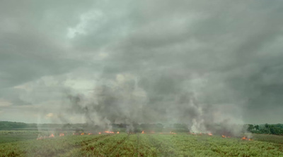 a large field with a lot of smoke coming out of it