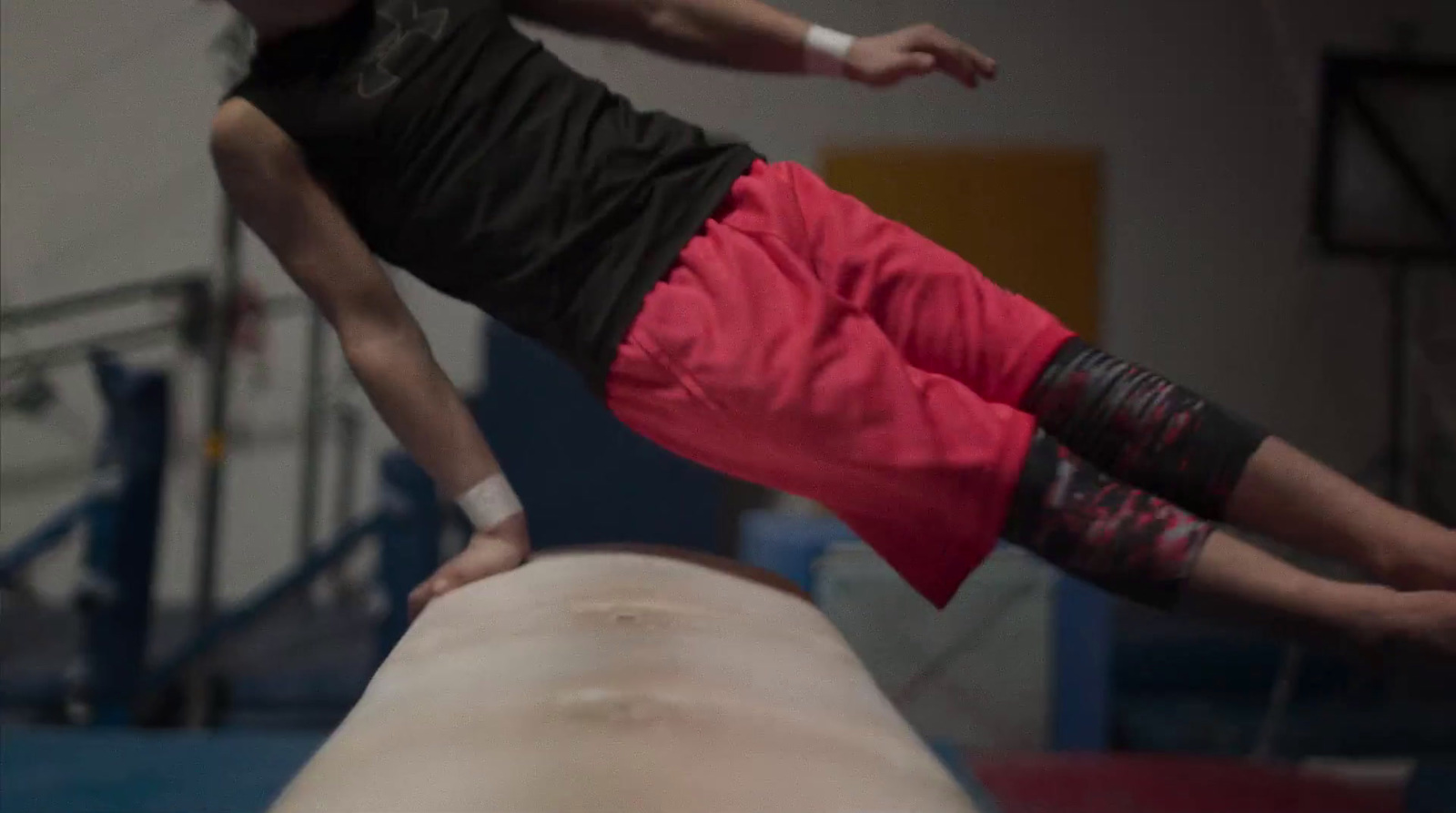 a man on a balance beam doing a trick