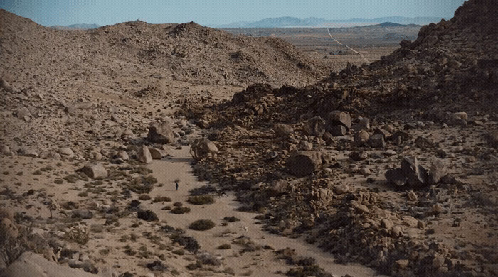 a dirt road in the middle of a desert