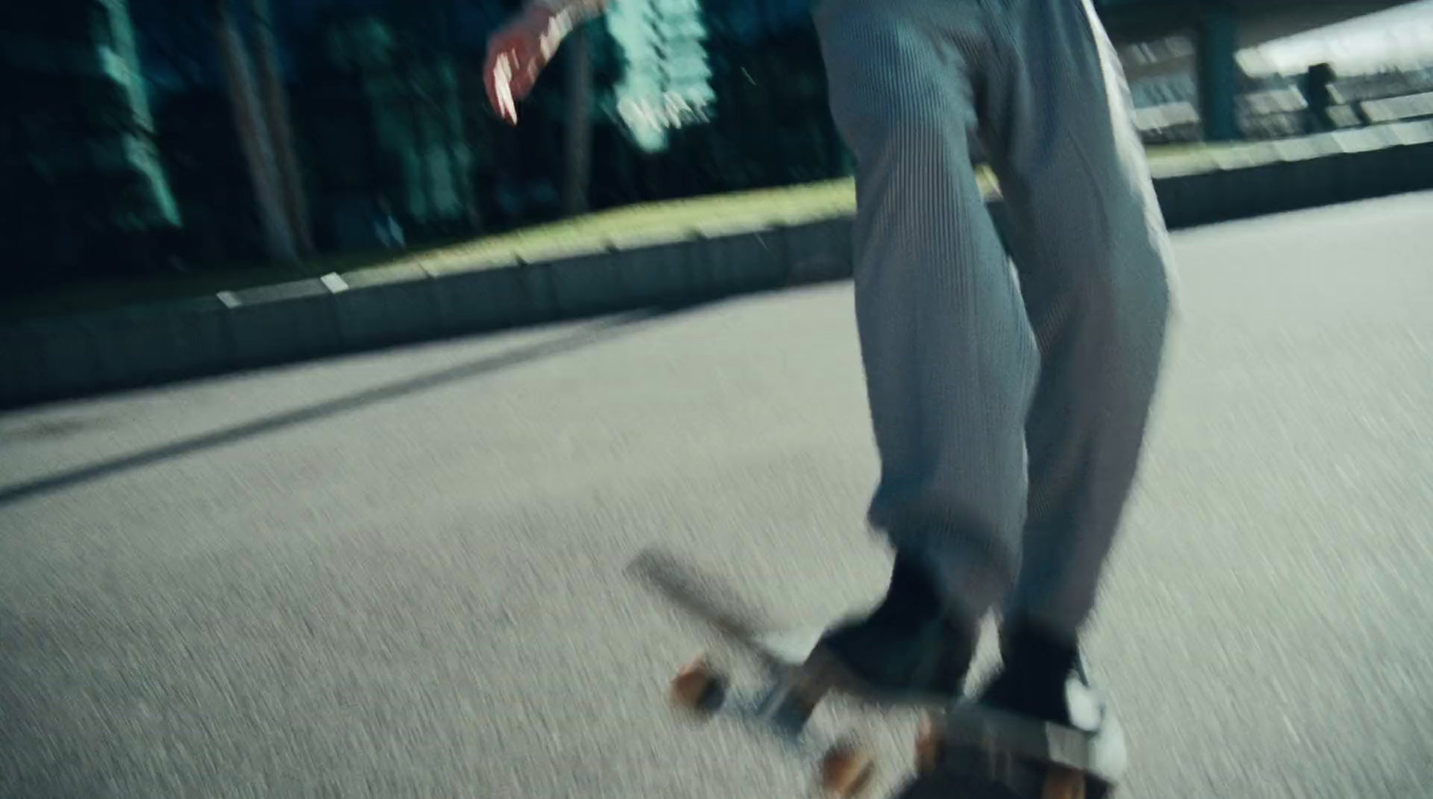 a man riding a skateboard down a street