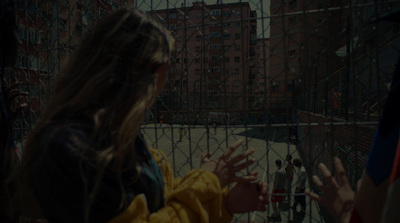 a group of people standing in front of a fence