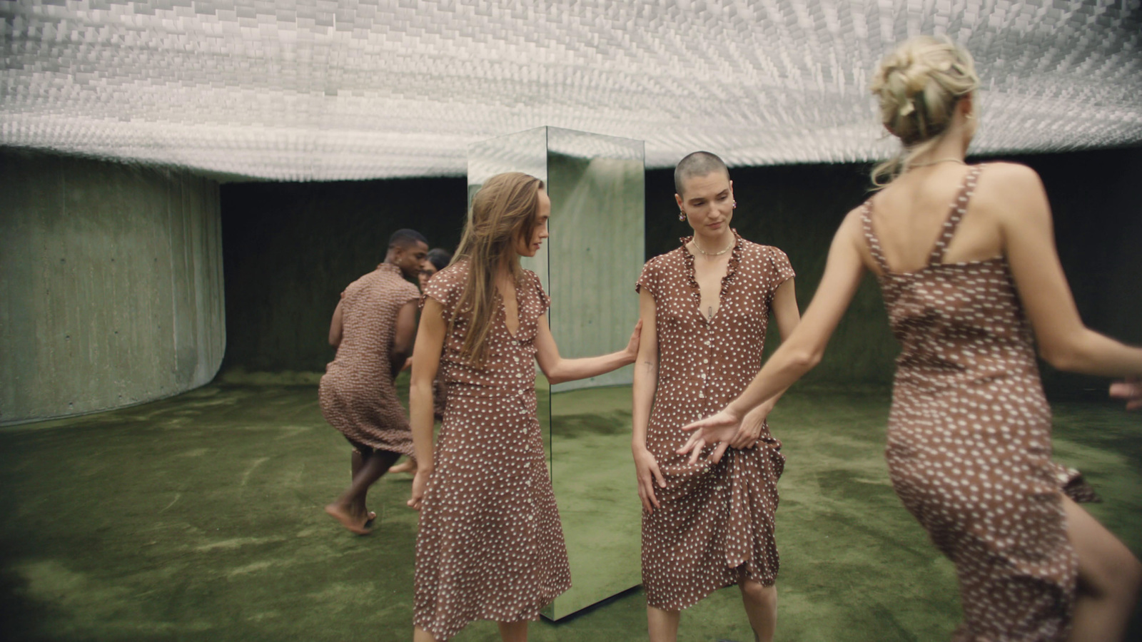 a group of women standing next to each other in front of a mirror