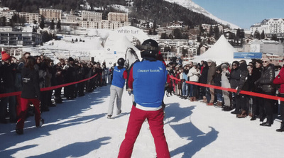 a group of people standing on top of a snow covered slope