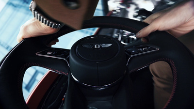 a close up of a person holding a steering wheel