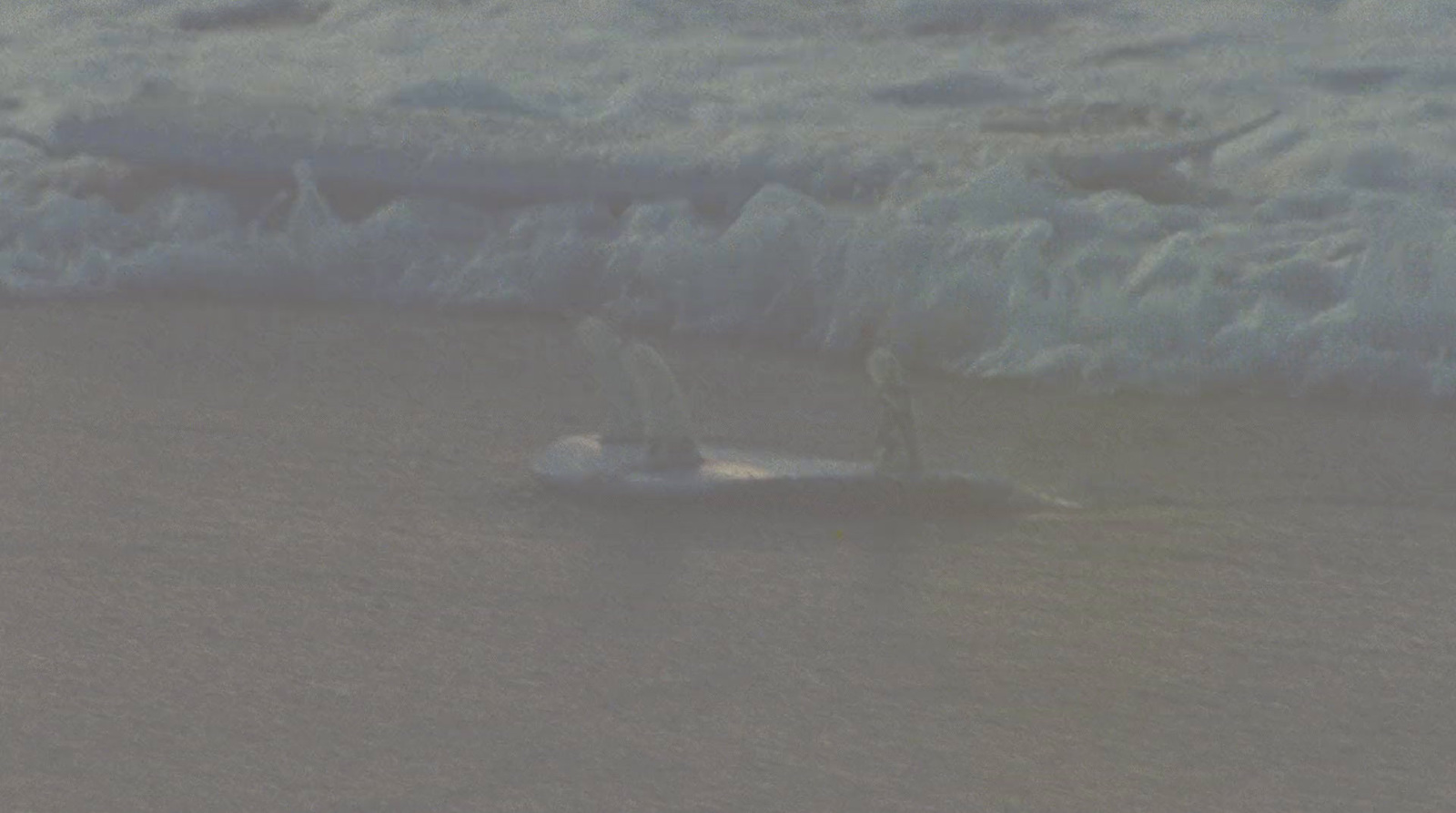 a person riding a surfboard on a body of water