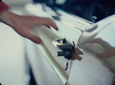 a close up of a person's hand on a car door handle