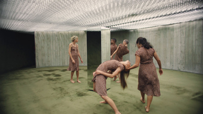 a group of women standing around each other in a room