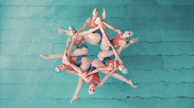 a group of people standing around in a pool