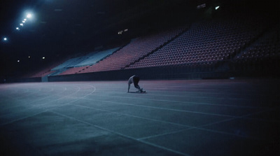 a man riding a skateboard on top of a tennis court