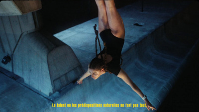 a woman hanging upside down on a rope