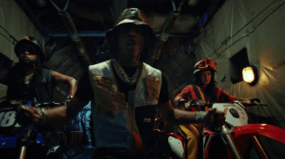 a group of men riding motorcycles in a tunnel