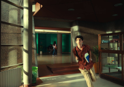 a man in a red shirt and tan pants