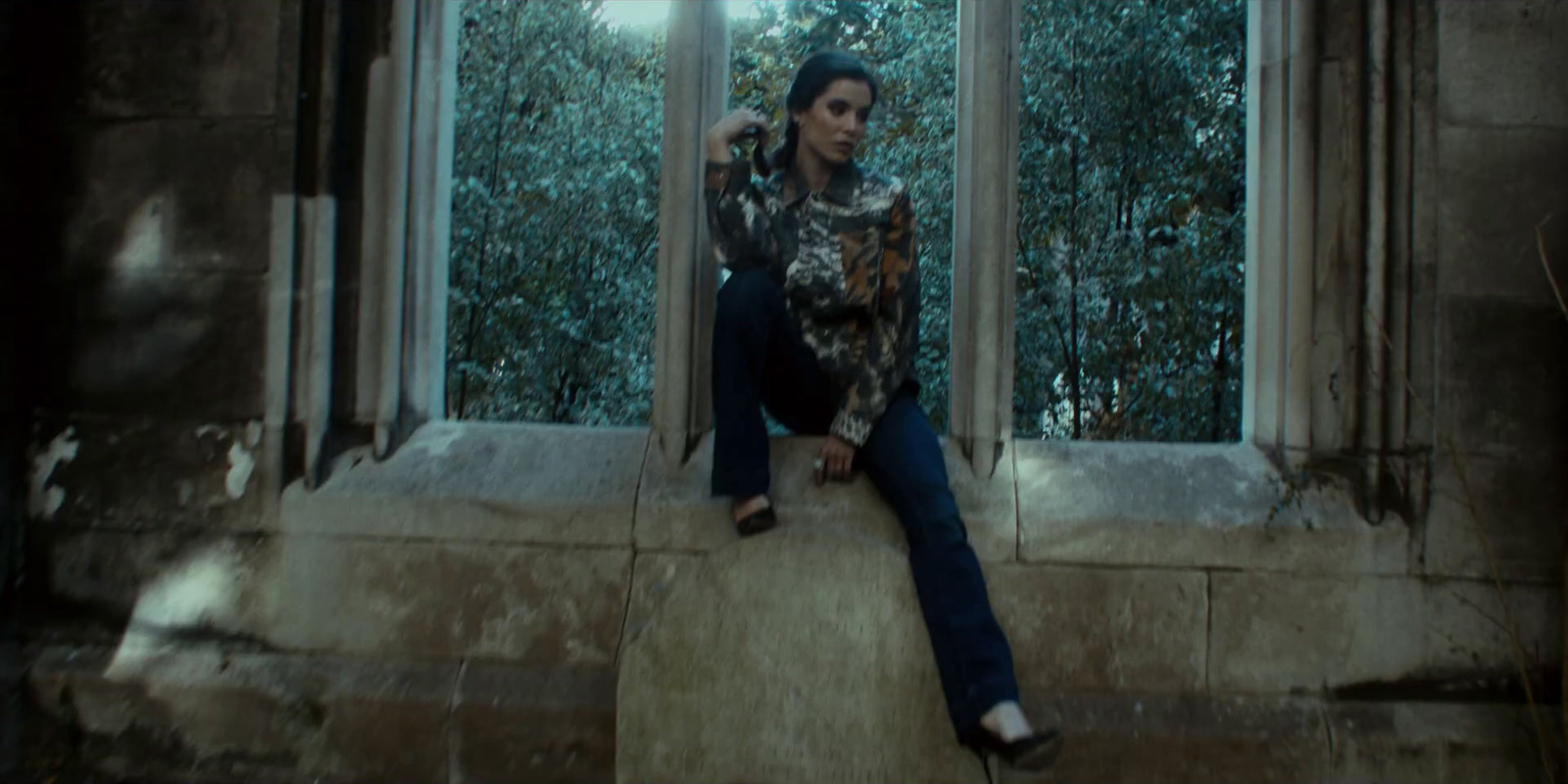 a woman sitting on a window sill in a building