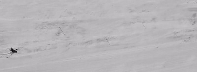 a person riding skis down a snow covered slope