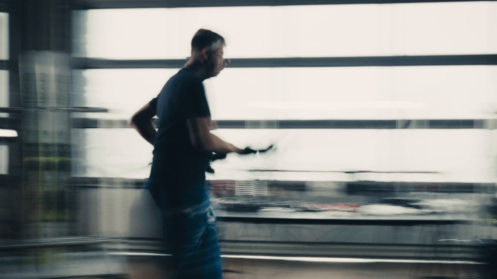 a blurry photo of a man standing in front of a window