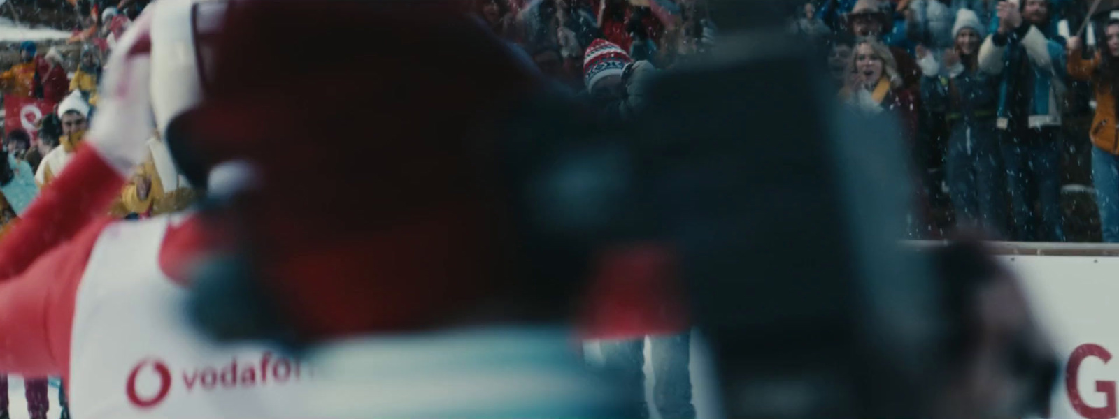 a red fire hydrant sitting in front of a crowd of people