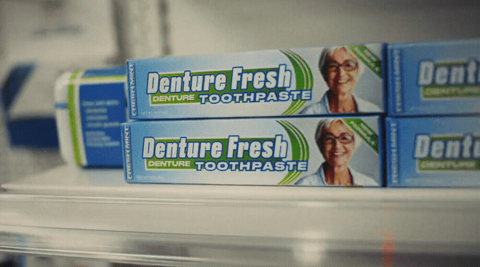 three denture fresh toothpaste on a shelf