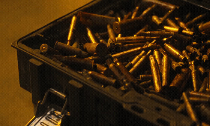 a box full of bullet casings on a table