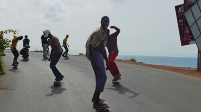 a group of people riding skateboards down a street