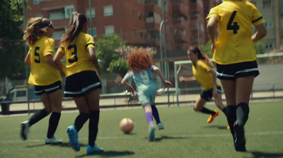 a group of young women kicking around a soccer ball