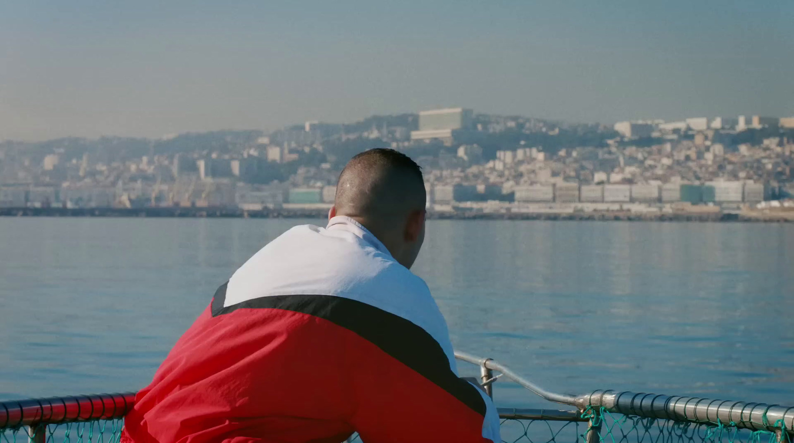 a man sitting on a boat looking out over the water