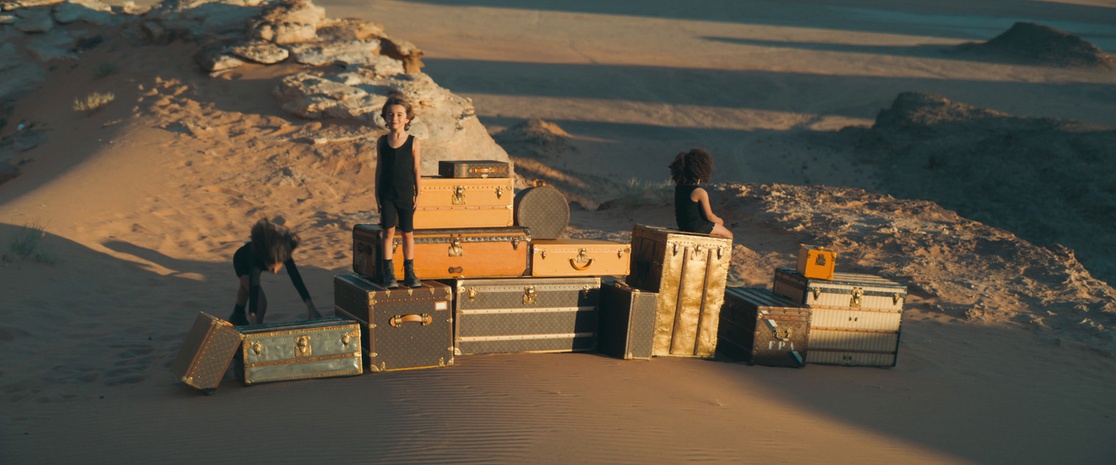 a group of people standing on top of a pile of luggage