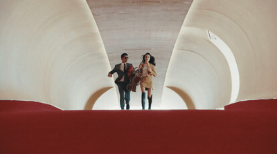 a man and a woman walking through a tunnel