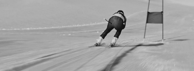 a man riding skis down a snow covered slope