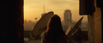 a woman looking out a window at a city