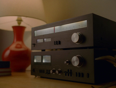 a stereo sitting on a table next to a lamp