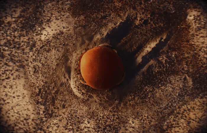 an egg sitting on top of a sandy surface